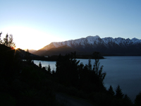 View of the sun setting behind The Remarkables in Queenstown