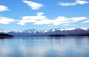 Lake Tekapo surrounded by snow capped mountains